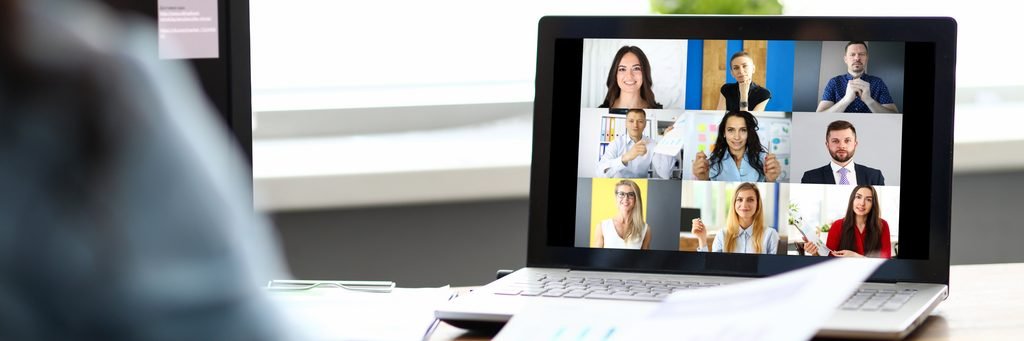 woman talking with international colleagues using online video chat service